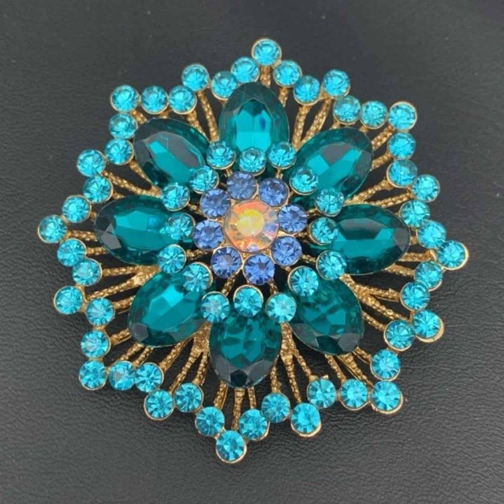 Gold tone and blue rhinestone brooch